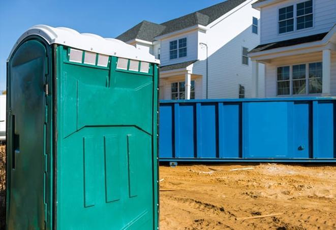 workers at a construction site take advantage of convenient porta potties